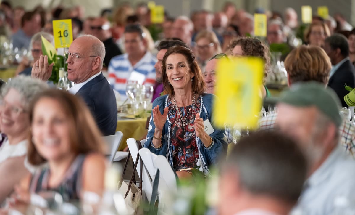 Guests clapping at the Summer Luncheon.
