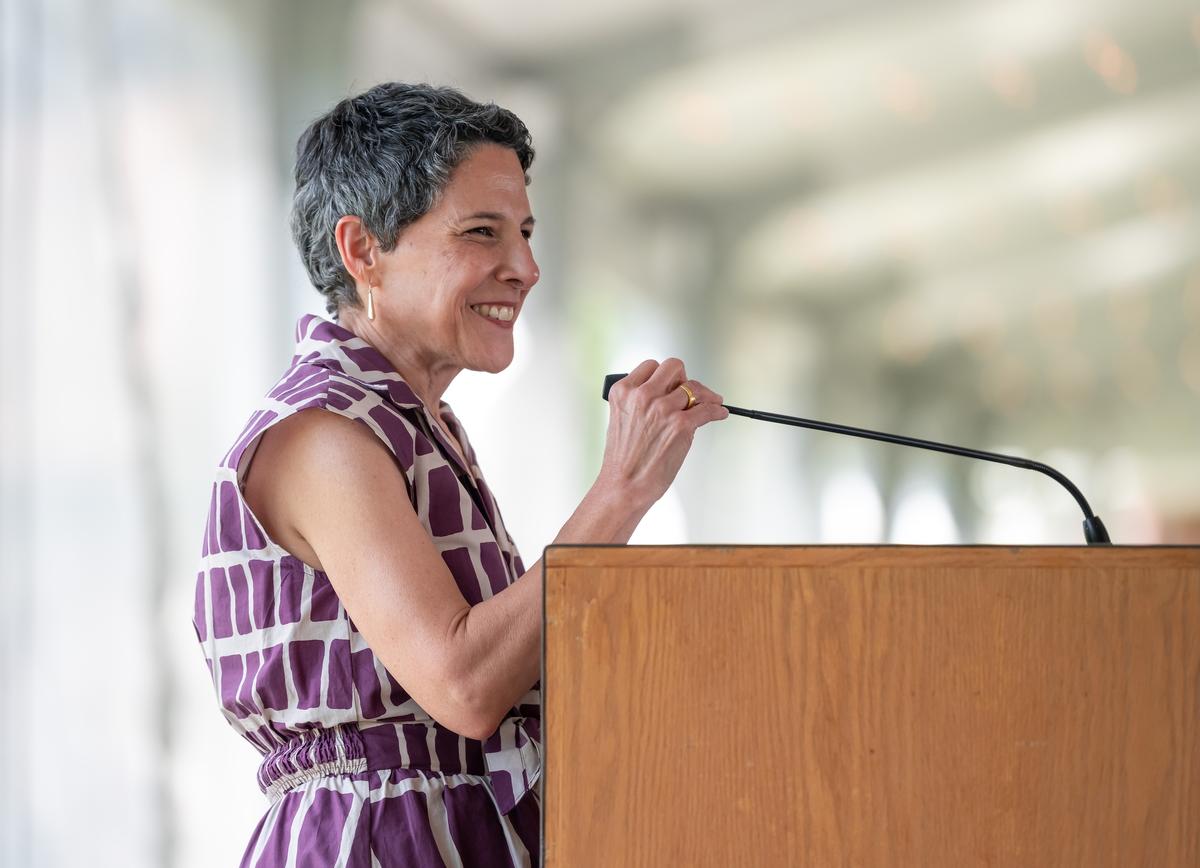 Carolyn Muzzy Director Jacqueline Terrassa speaking at the podium at the Summer Luncheon.