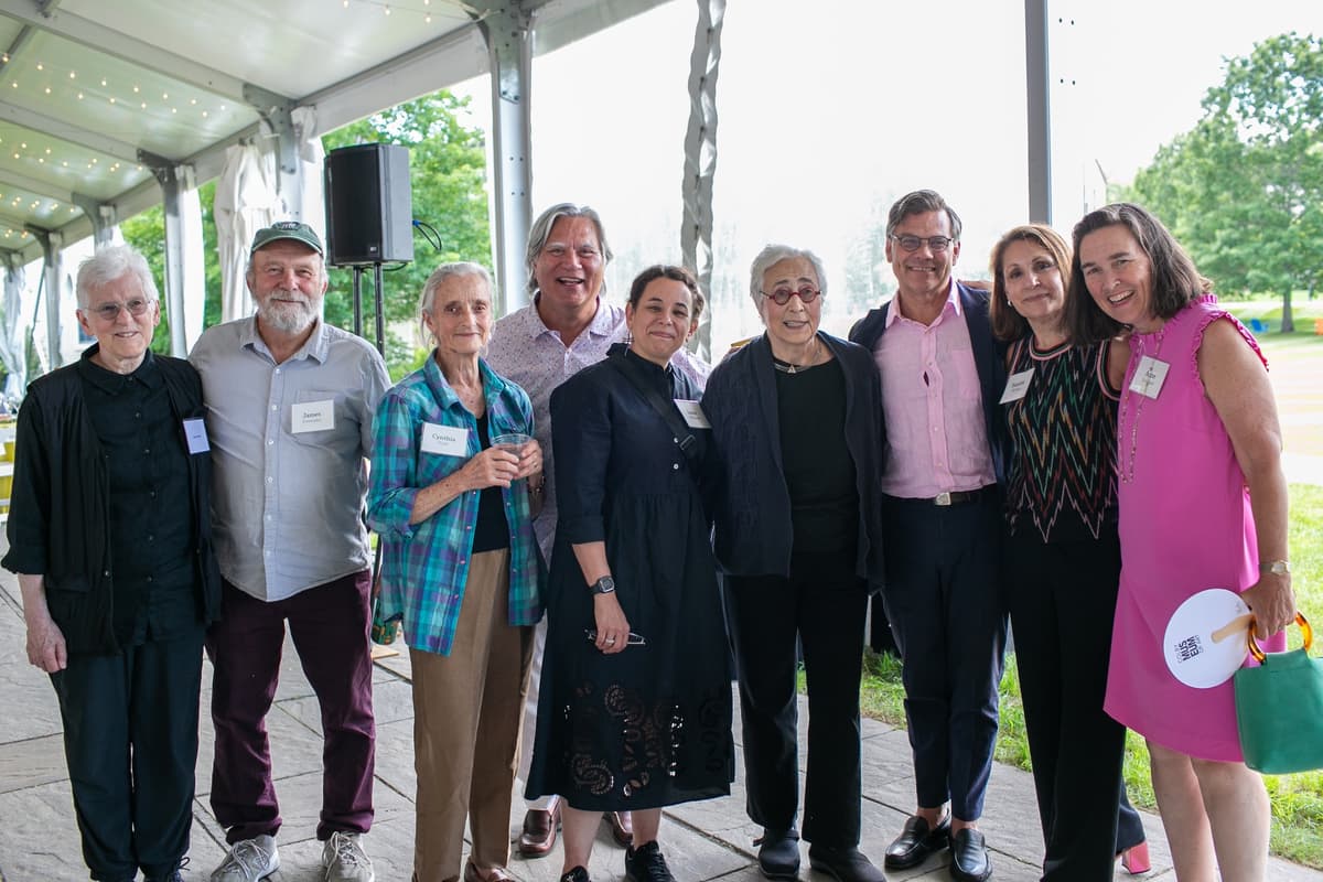 A group of people smile for the camera at the Summer Luncheon.