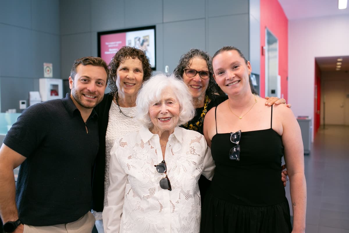 A group of people smiling for a photo in the museum lobby.