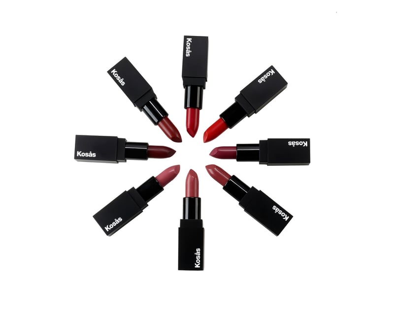 Eight Kosás lipstick bullets radiating from a centre point on white, each tip angled inward to show its shade
