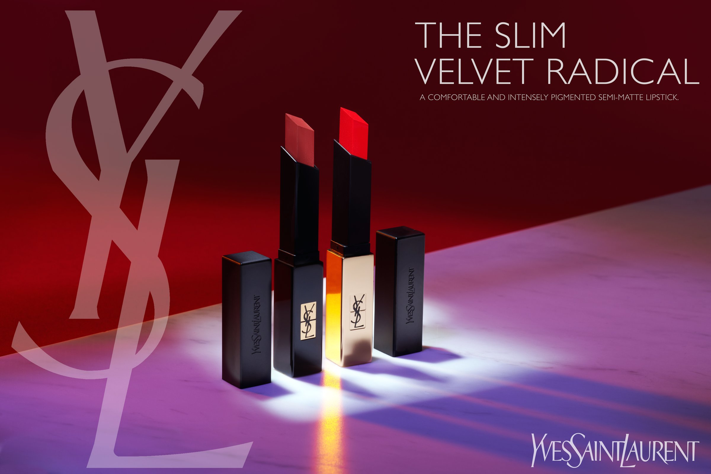 Three Yves Saint Laurent Slim Velvet Radical lipsticks standing on a red and purple gradient ground
