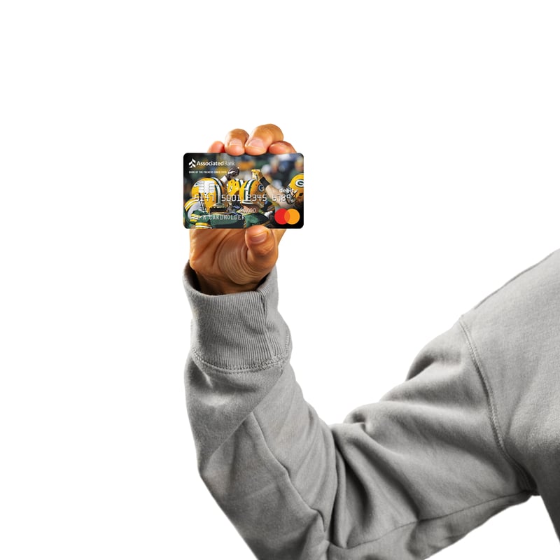 A hand holds up a patterned Associated Bank debit card against white