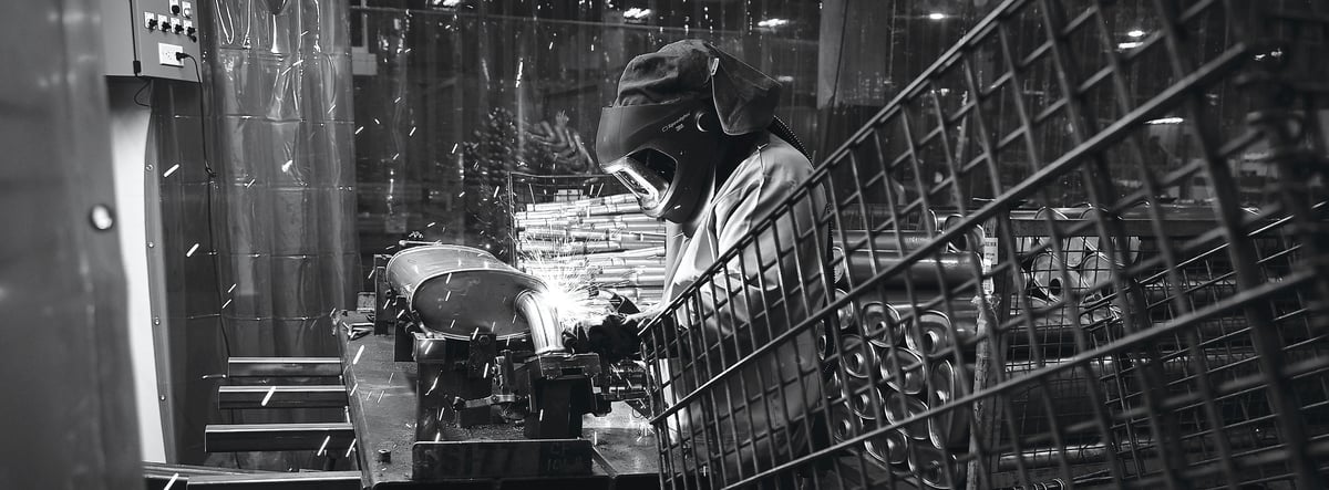 A high-contrast black and white industrial scene of steel structure and shadow