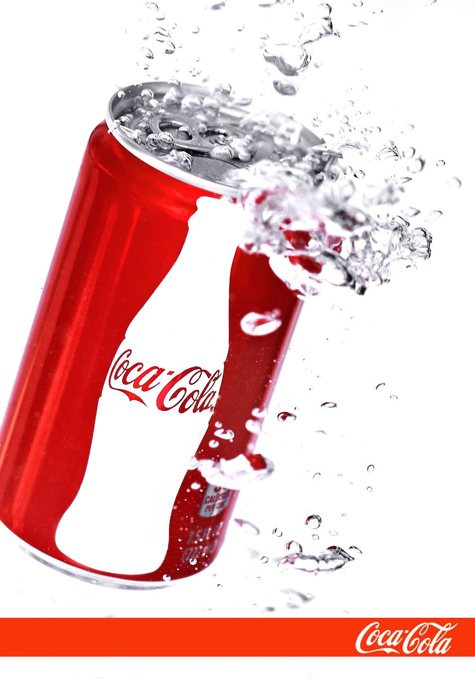 A Coca-Cola can tilted mid-air with liquid and ice splashing around it, shot on white