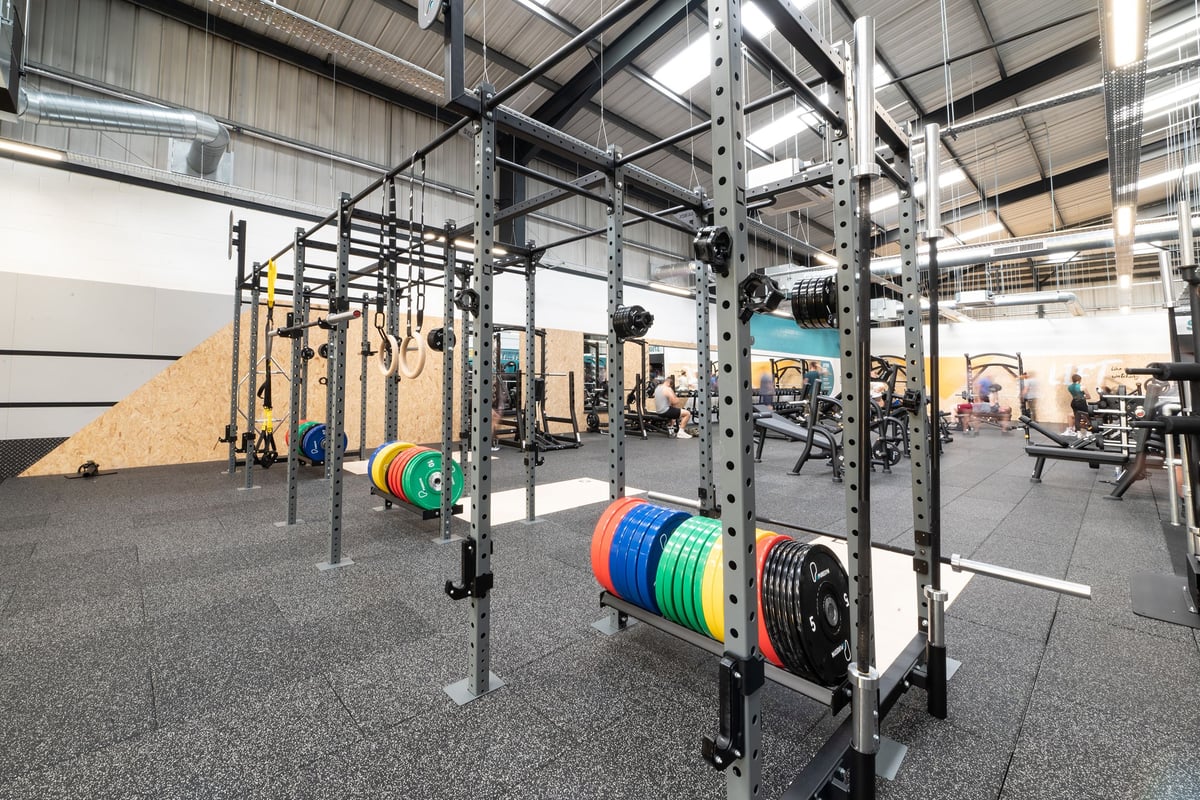 PureGym Dover: Strength racks, colourful weight plates, rubberised floors in a spacious weight training area.