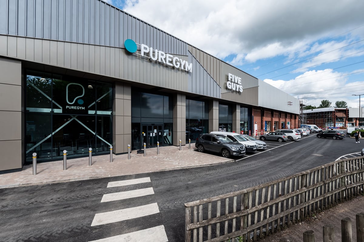 PureGym Cheshunt Brookfield Shopping Park: The exterior of a gym with its logo, parking spaces, and entrance visible.
