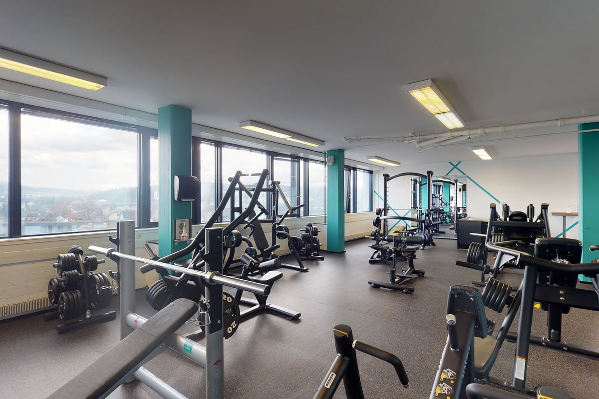 PureGym Dietikon: Floor-to-ceiling windows, exercise machines, treadmills, and weight racks.
