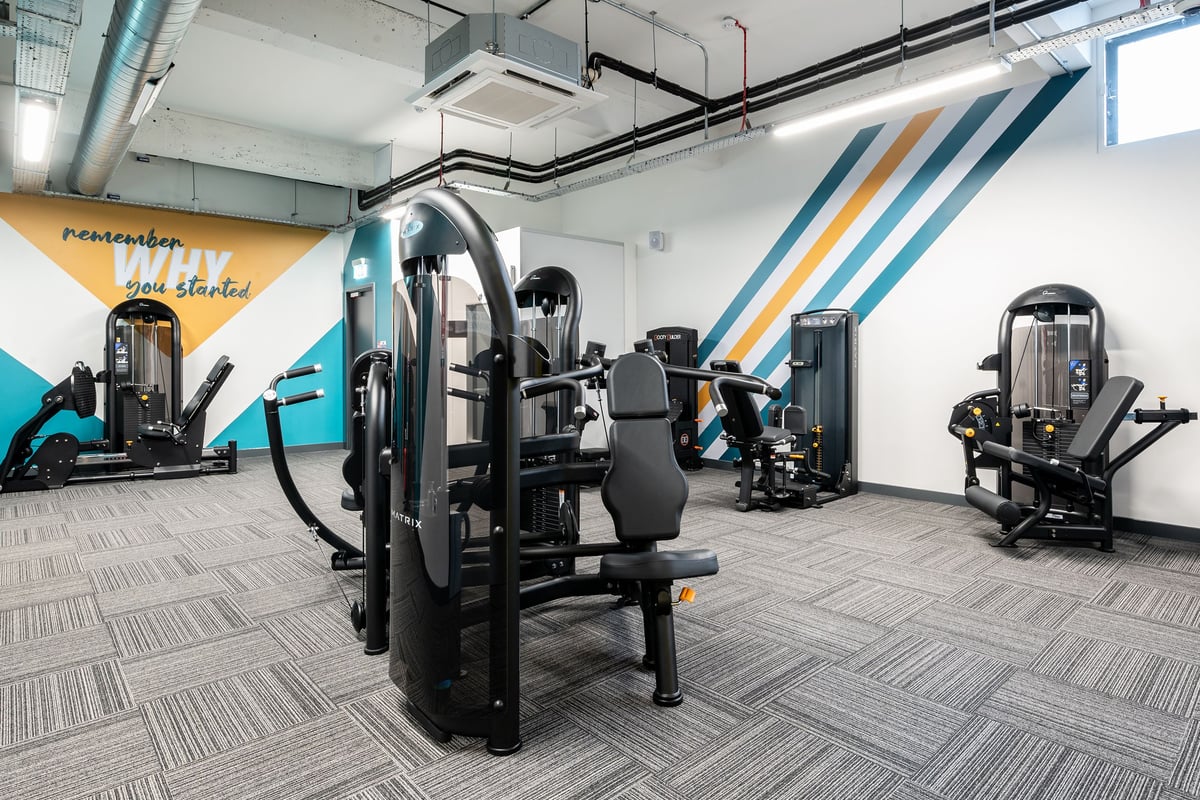 PureGym London Bethnal Green: Resistance machines for strength training, arranged in rows with motivational wall art.