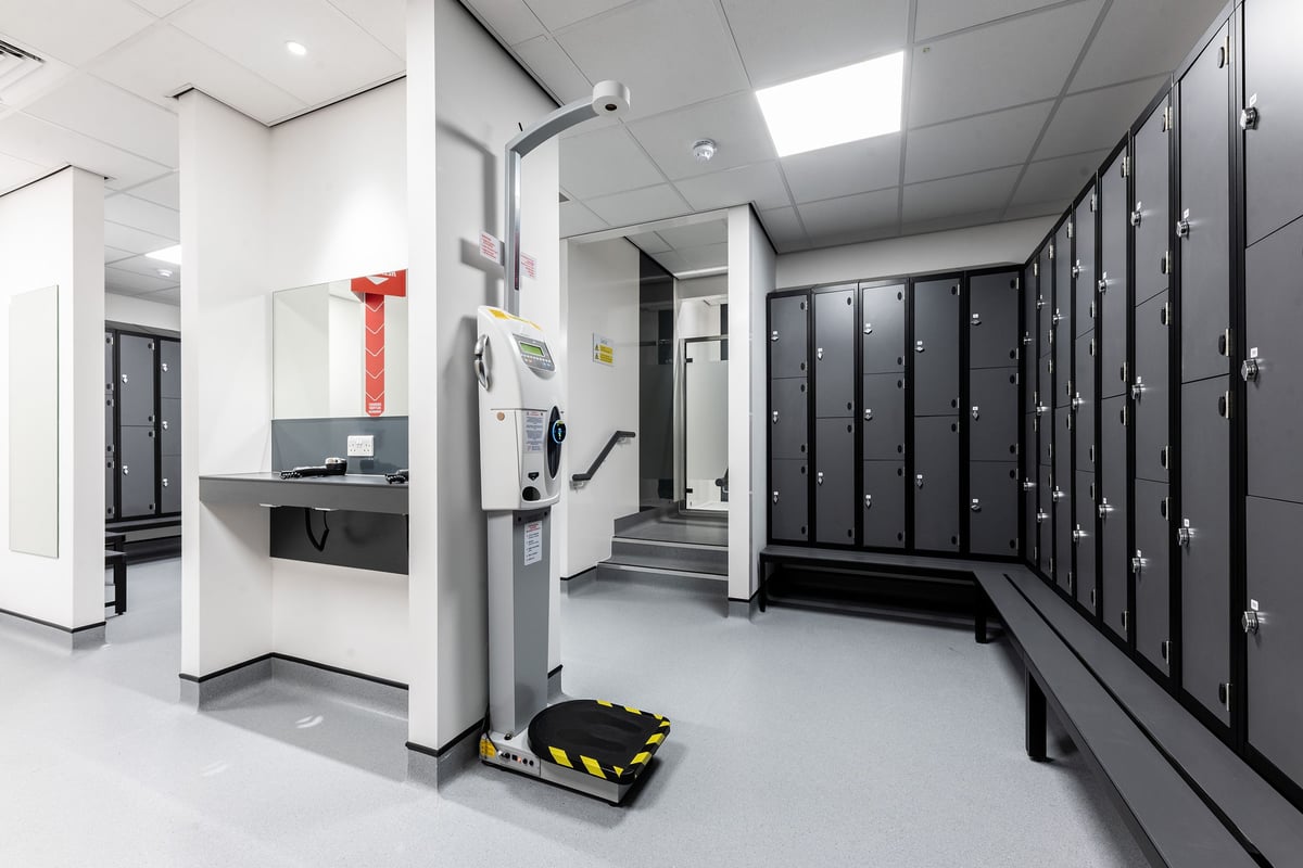 PureGym Solihull Sears Retail Park: Rows of lockers, benches, and an automated external defibrillator.
