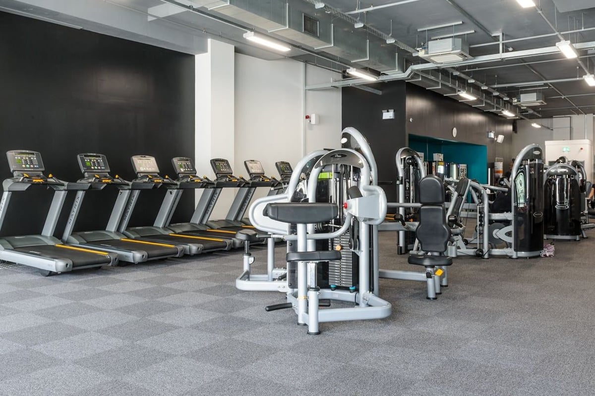 PureGym Derby City Centre: Rows of treadmills alongside weight machines and resistance equipment in a spacious gym interior.
