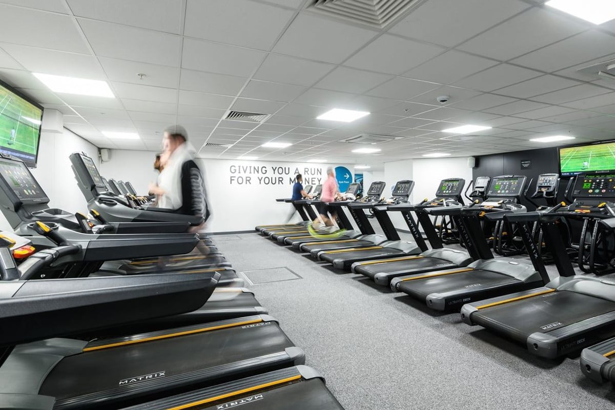 PureGym London Moorgate: Rows of treadmills and other cardio machines in a spacious gym area.