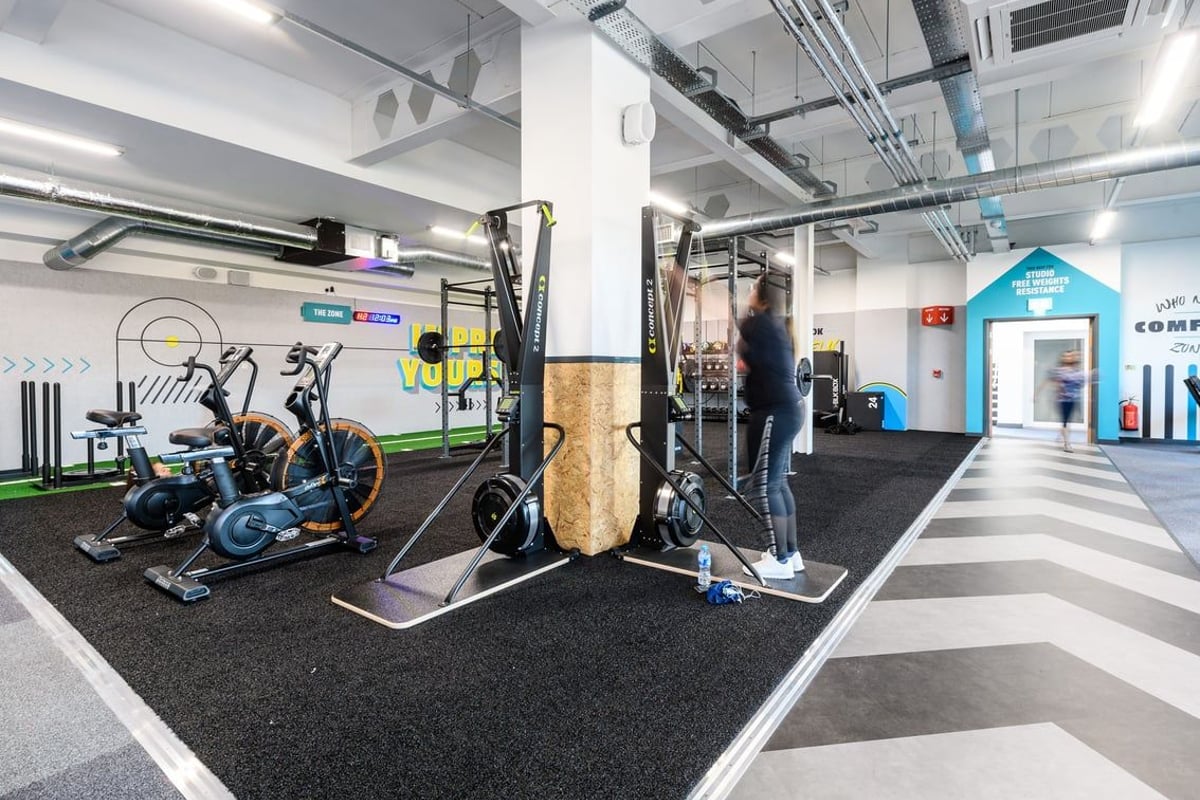 PureGym Telford: Exercise bikes, weight machines, resistance bands, rubberized flooring in a gym setting.