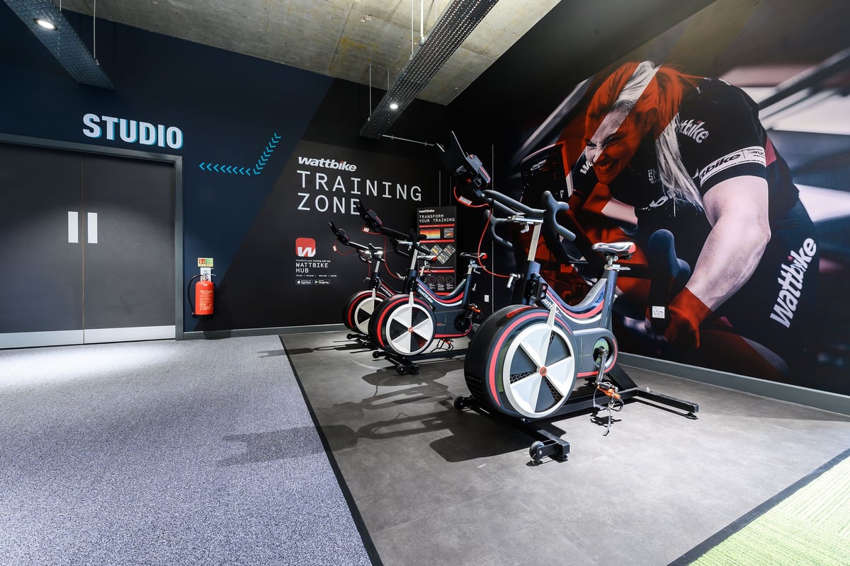 PureGym London Fulham: Stationary training cycles, resistance bands, and branded studio signage.