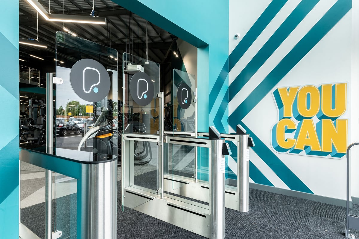 PureGym Nottingham West Bridgford: Glass partitioned lobby with branded revolving doors and "You Gan" signage.