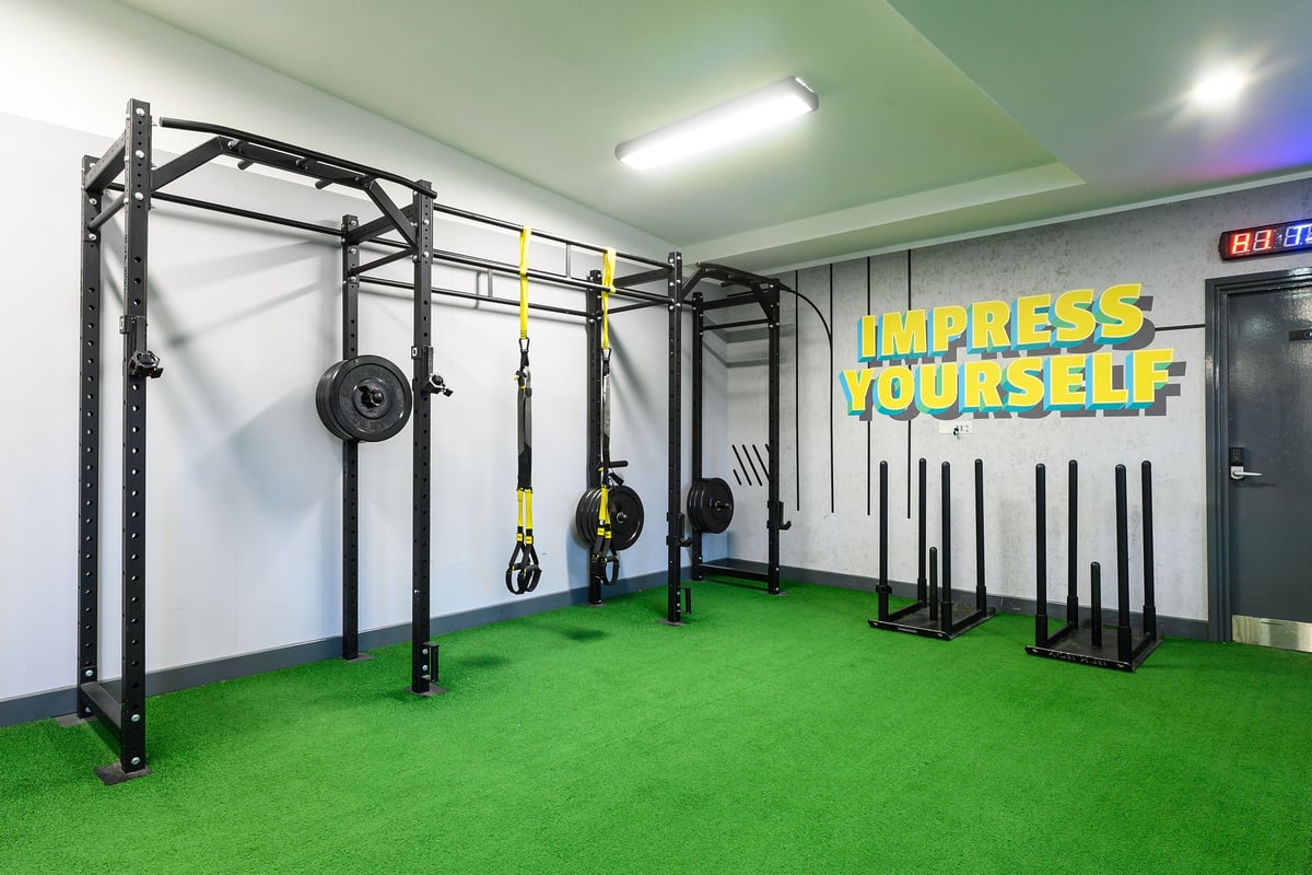 PureGym Oxford Central: Fitness rig, weight plates, squat racks, turf area, weight benches, dumbbell racks in a gym studio.