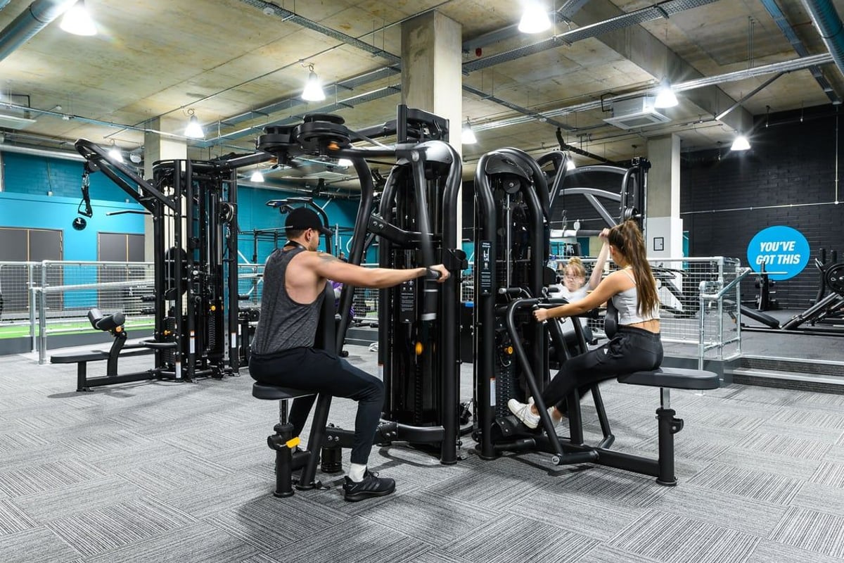 PureGym London Kidbrooke Village: Resistance machines, weight stacks, benches, and rubberized flooring in a gym space.