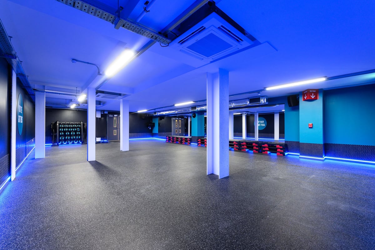 PureGym Bath Spring Wharf: Rows of red exercise balls, blue-lit facility, mirrored walls.
