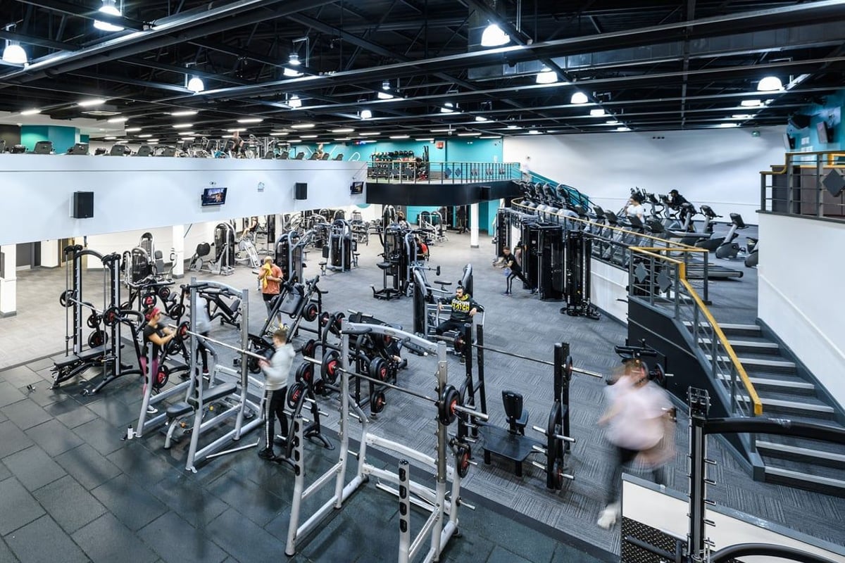 PureGym Portsmouth Commercial Road: Rows of weight machines, plate-loaded equipment, squat racks, and rubberized floors.