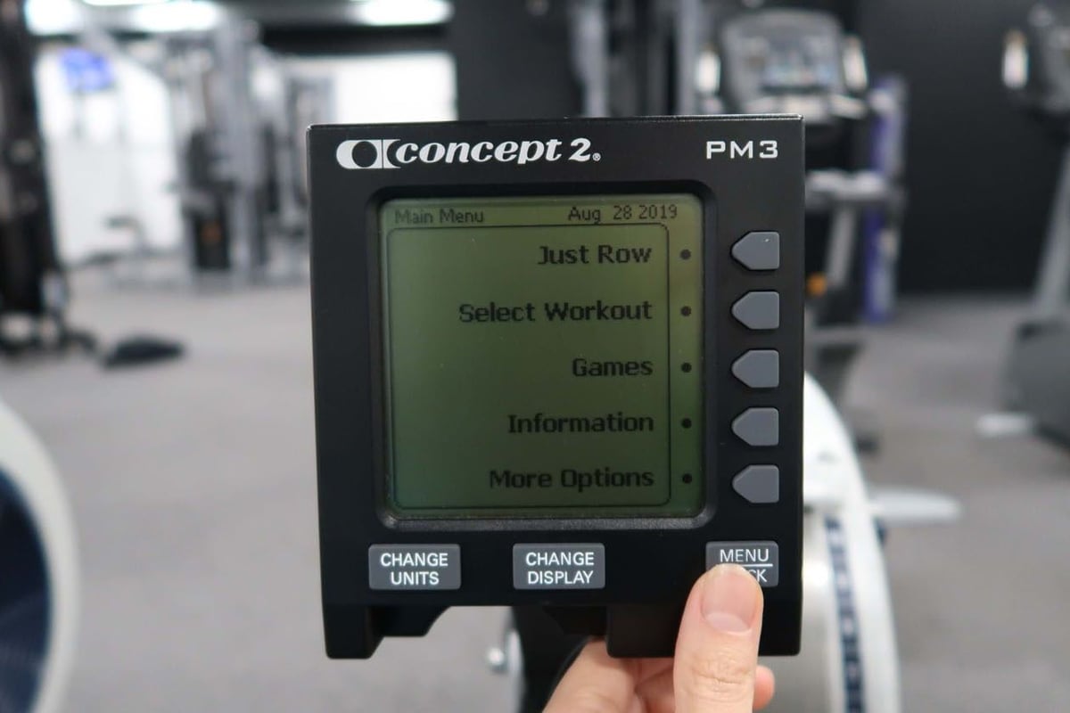 Concept2 PM3 rowing machine monitor showing workout menu options in a gym setting