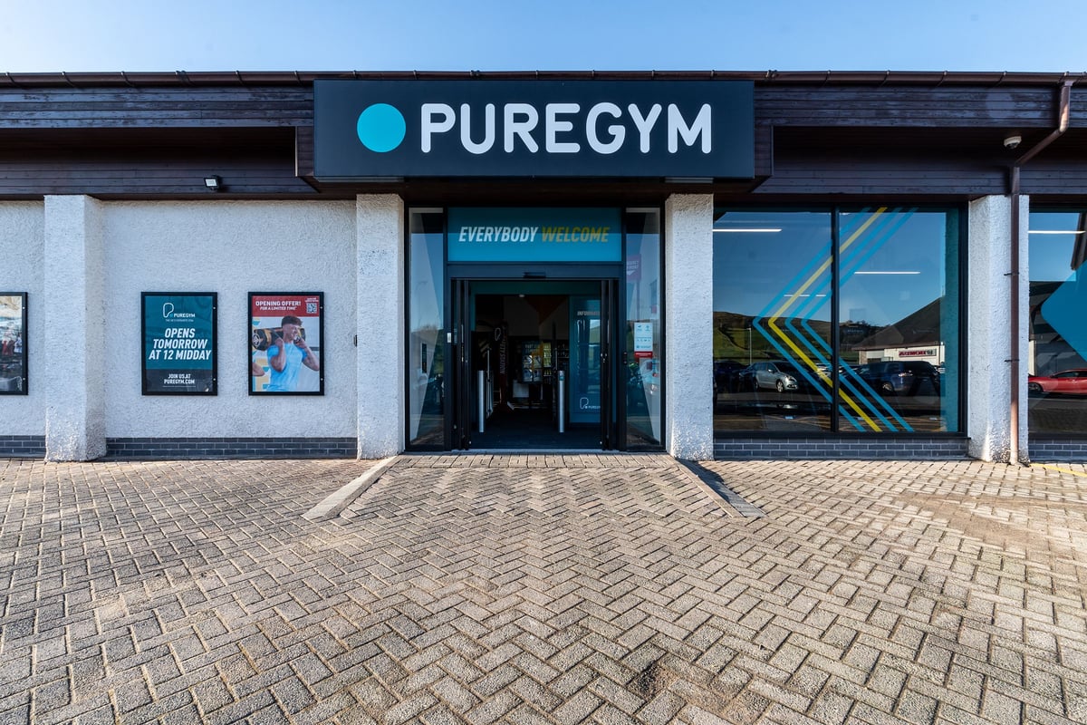 PureGym Kendal: Gym entrance with logo, windows showcasing exercise equipment inside.