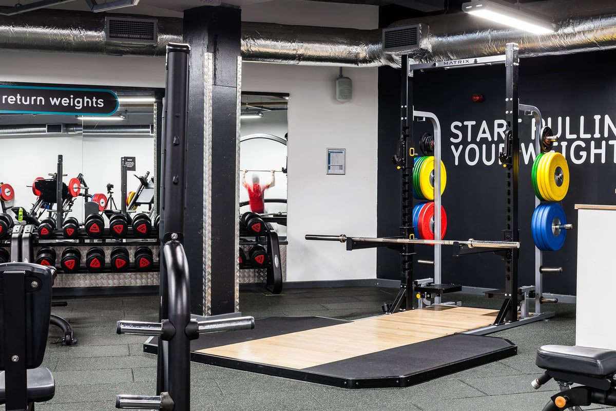 PureGym Manchester Stretford: Weight racks, platforms, pulling cages, barbell and dumbbell sets and wall mirrors.