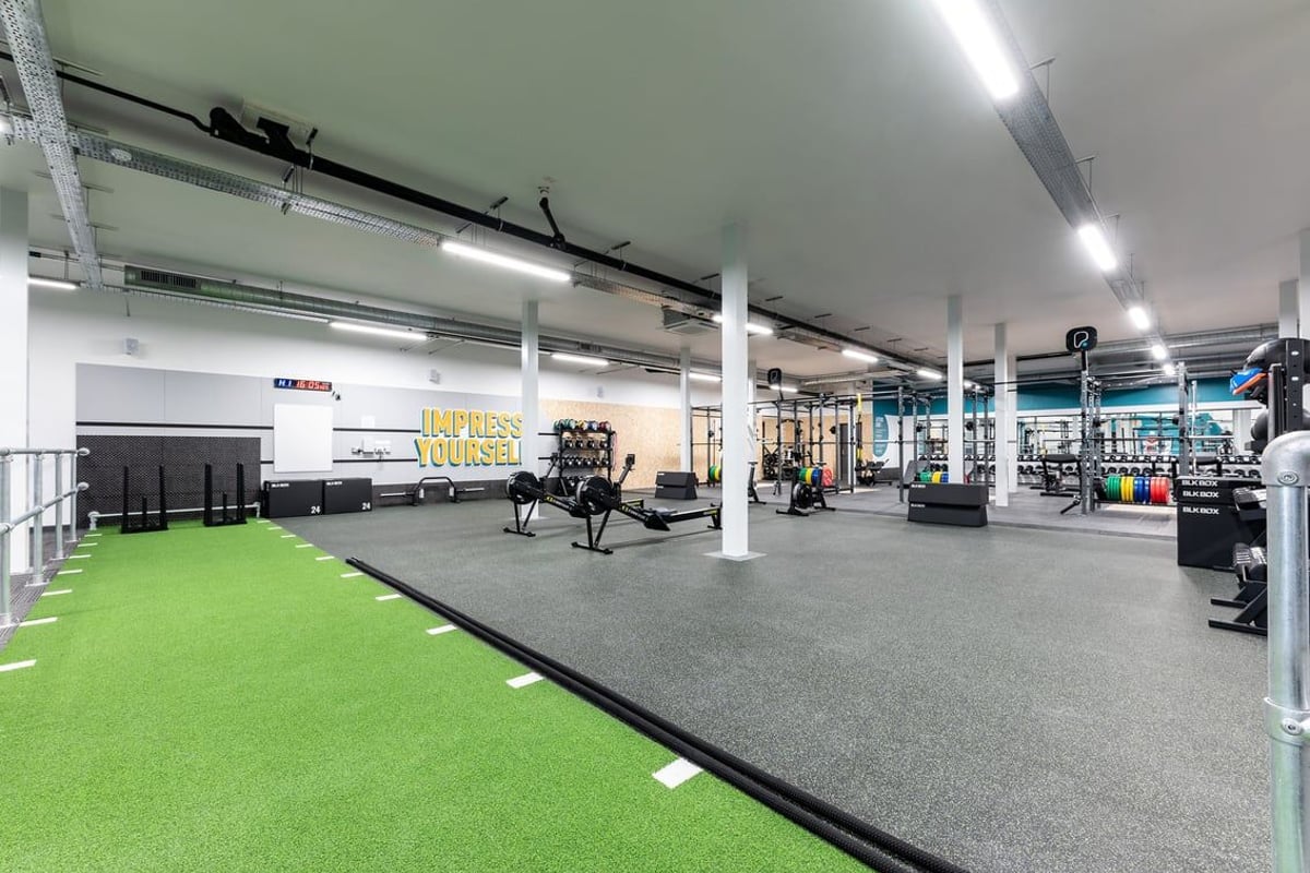 PureGym Sevenoaks: Weight racks, turf area, free weights, benches, and rubberised flooring in a gym studio.