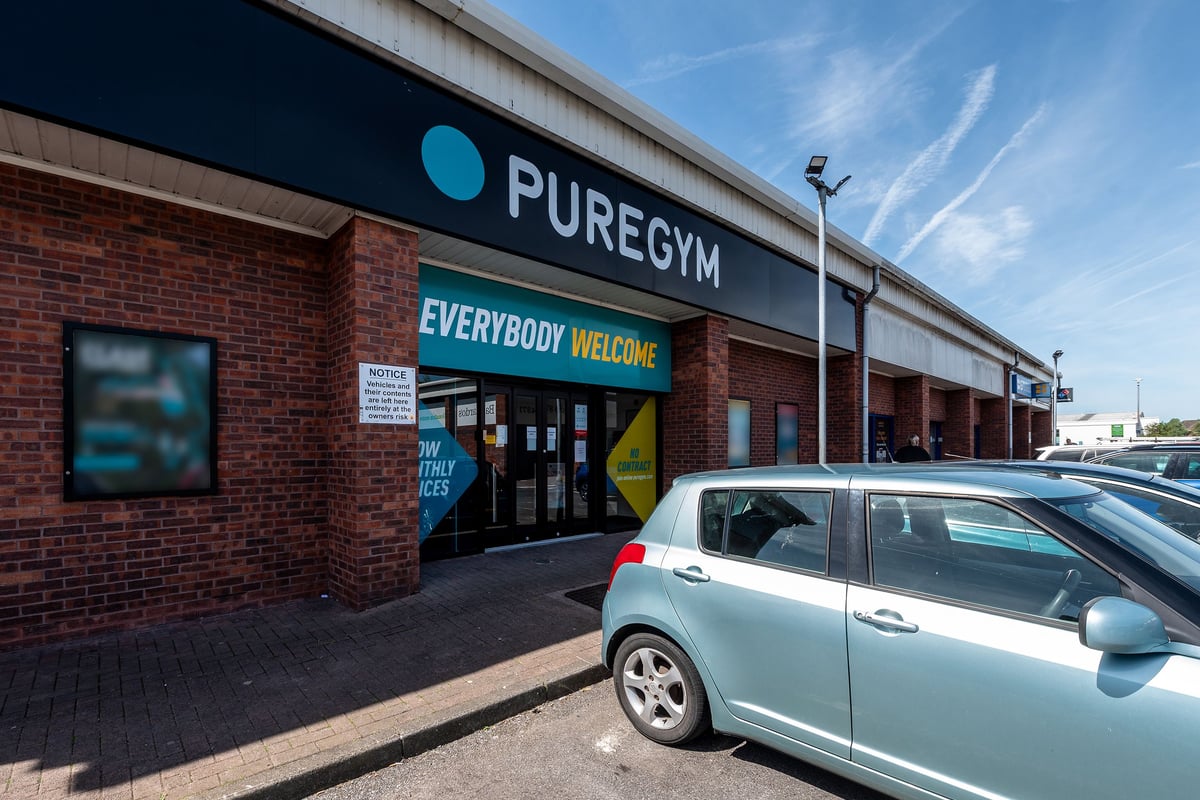PureGym Aberdare: The gym exterior with 'PUREGYM' signage, a brick building, and parked cars visible.