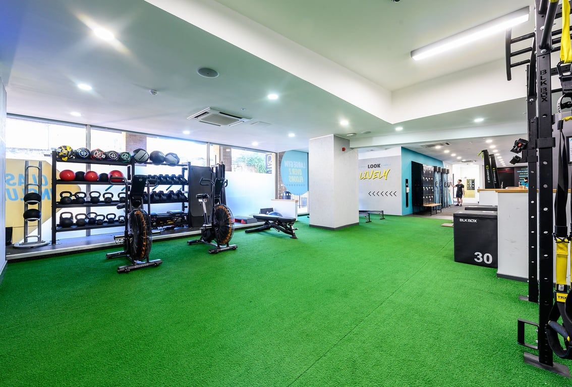 PureGym Oxford Central: Weight racks, resistance machines, artificial turf flooring, and self-service kiosks.