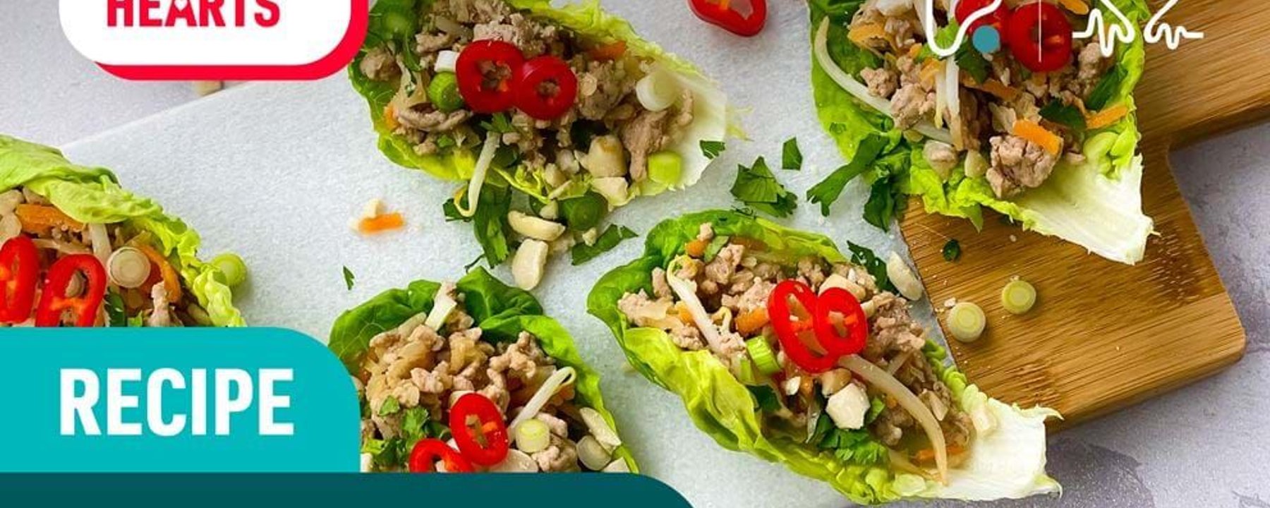Lettuce cups filled with minced meat, chopped vegetables, and sliced red chili peppers