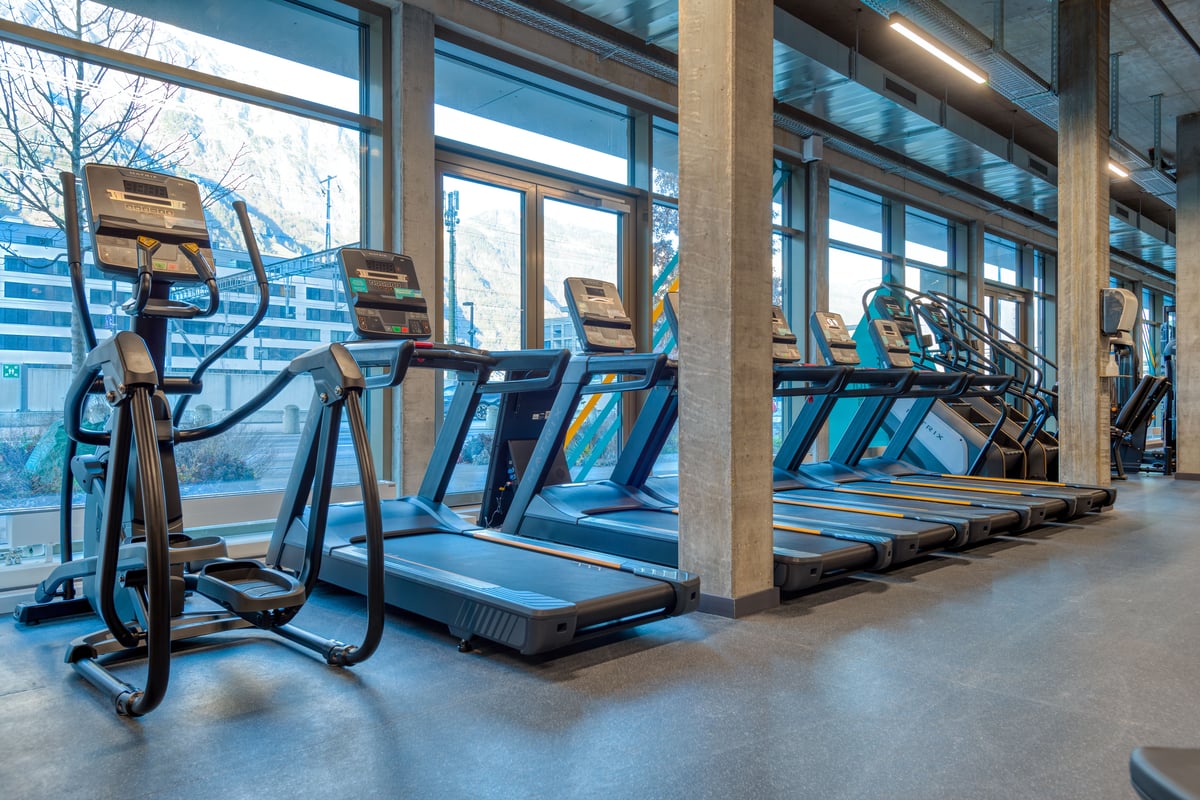 PureGym Altdorf: a row of treadmills facing a full-length window in a gym