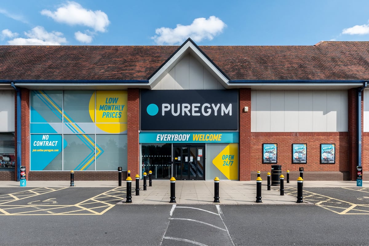 PureGym Shrewsbury Meole Brace: Gym exterior, parking spaces, low monthly prices advertised.