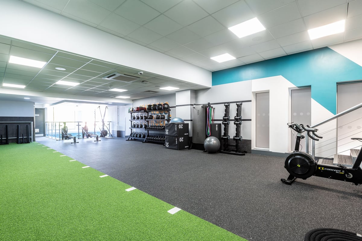 PureGym Sutton Coldfield: Weight racks, cardio machines, free weights, turf area with rubberised flooring and mirrored walls.
