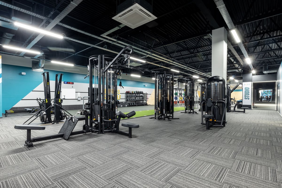PureGym Washington: Resistance machines, squat racks, weight plates, and rubberized flooring in a well-lit gym space.