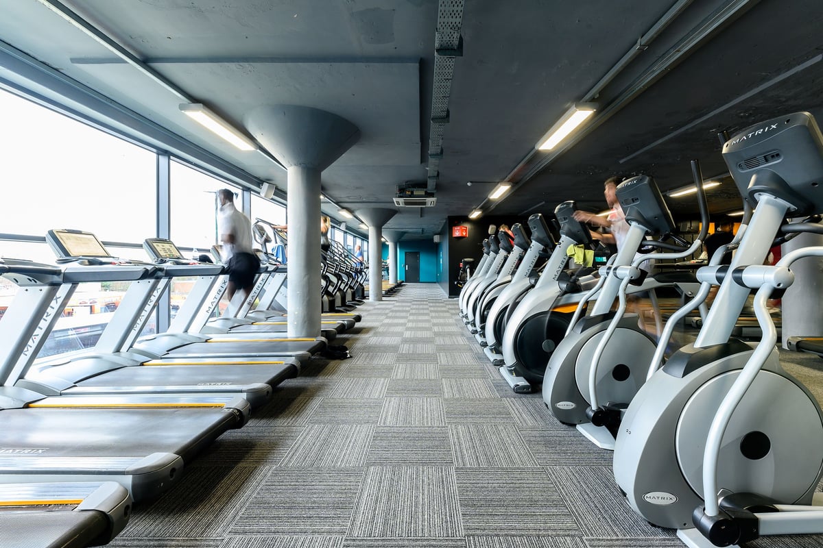 PureGym Nottingham Basford: Rows of treadmills and elliptical machines in a modern gym interior.