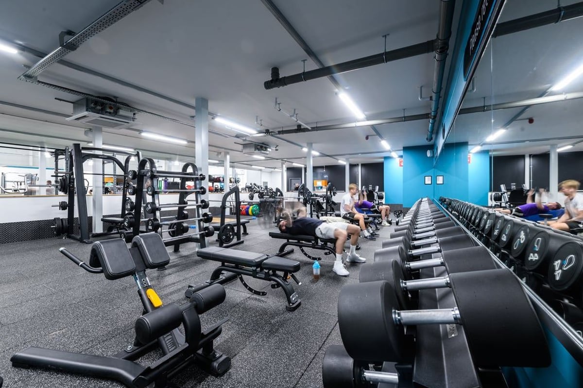 PureGym Folkestone: Resistance machines, free weights, benches, rubberized floors in a brightly lit gym interior.