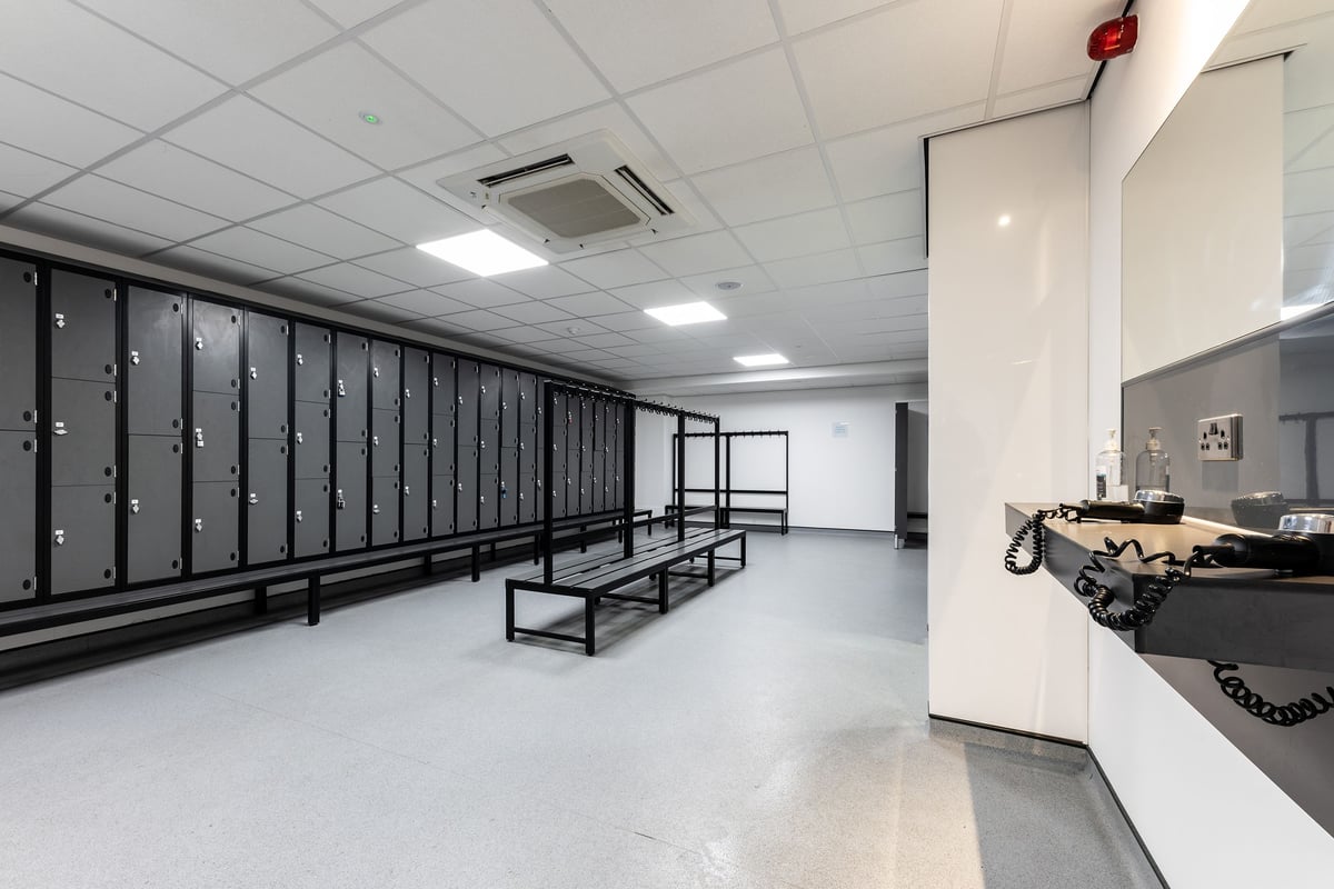 PureGym Lincoln St Marks Centre: changing rooms with rows of lockers and benches and a hairdyer