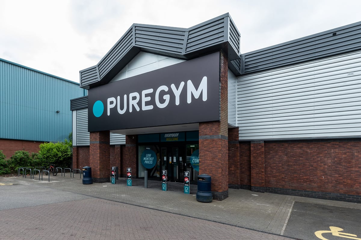 PureGym Macclesfield Silk Road: Gym exterior with branding, seating area, and entrance.