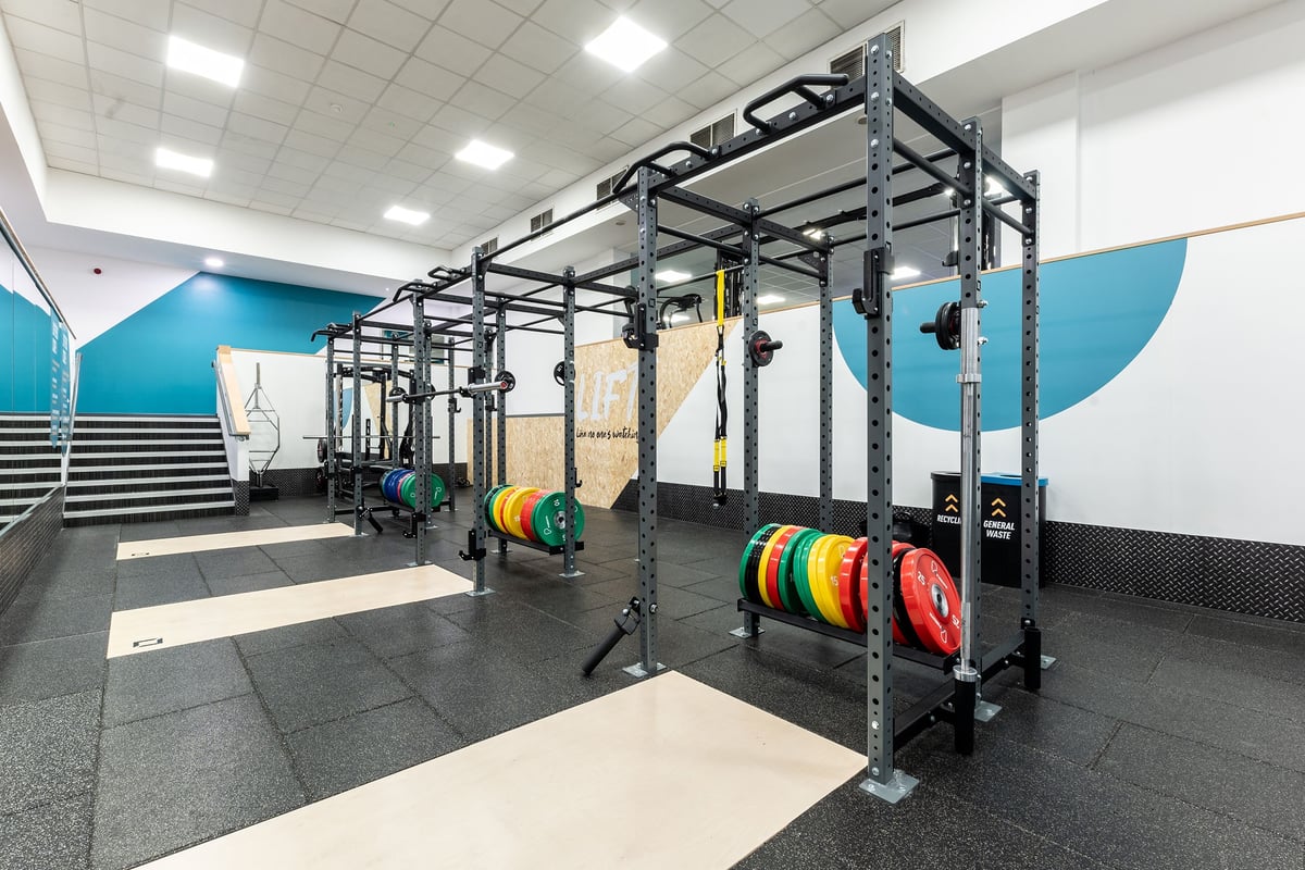 PureGym Purley: Resistance rig, weighted plates, rubberized flooring, mirrored wall in gym studio.