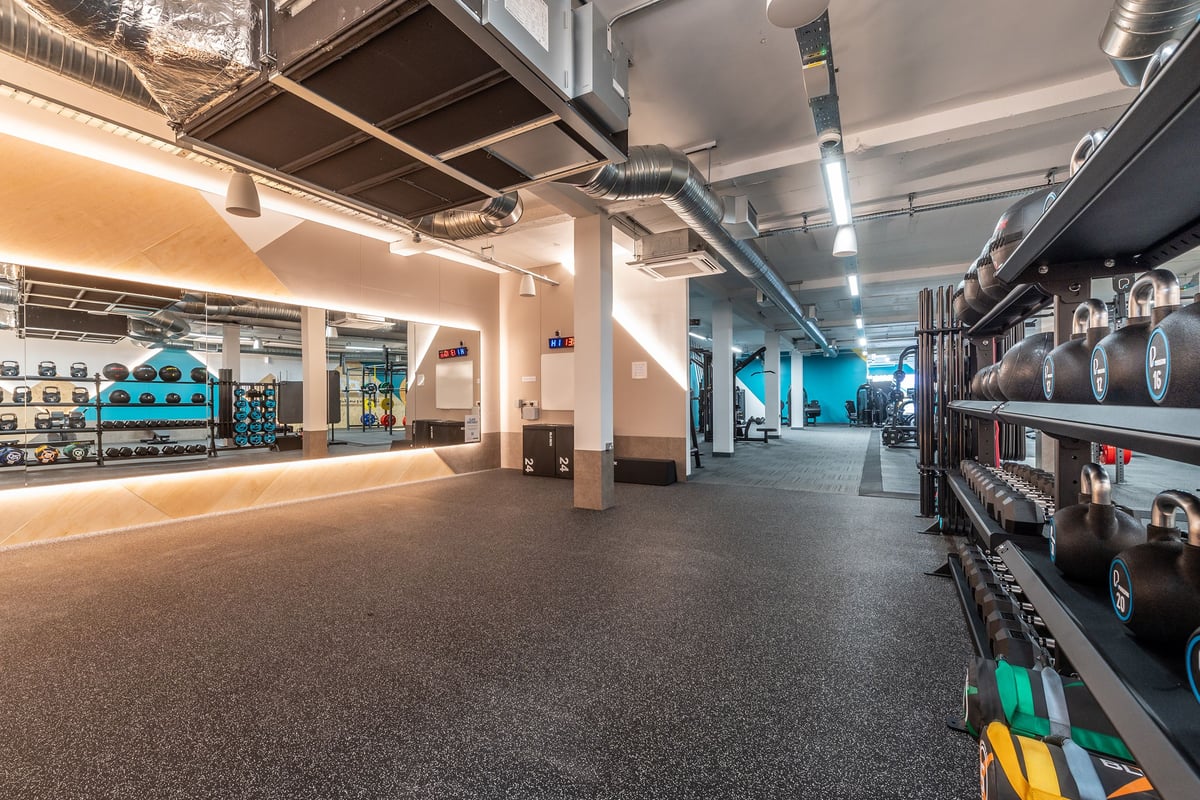 PureGym London Hornchurch: Weight racks, treadmills, resistance machines, and exposed ducts in a contemporary gym setting.