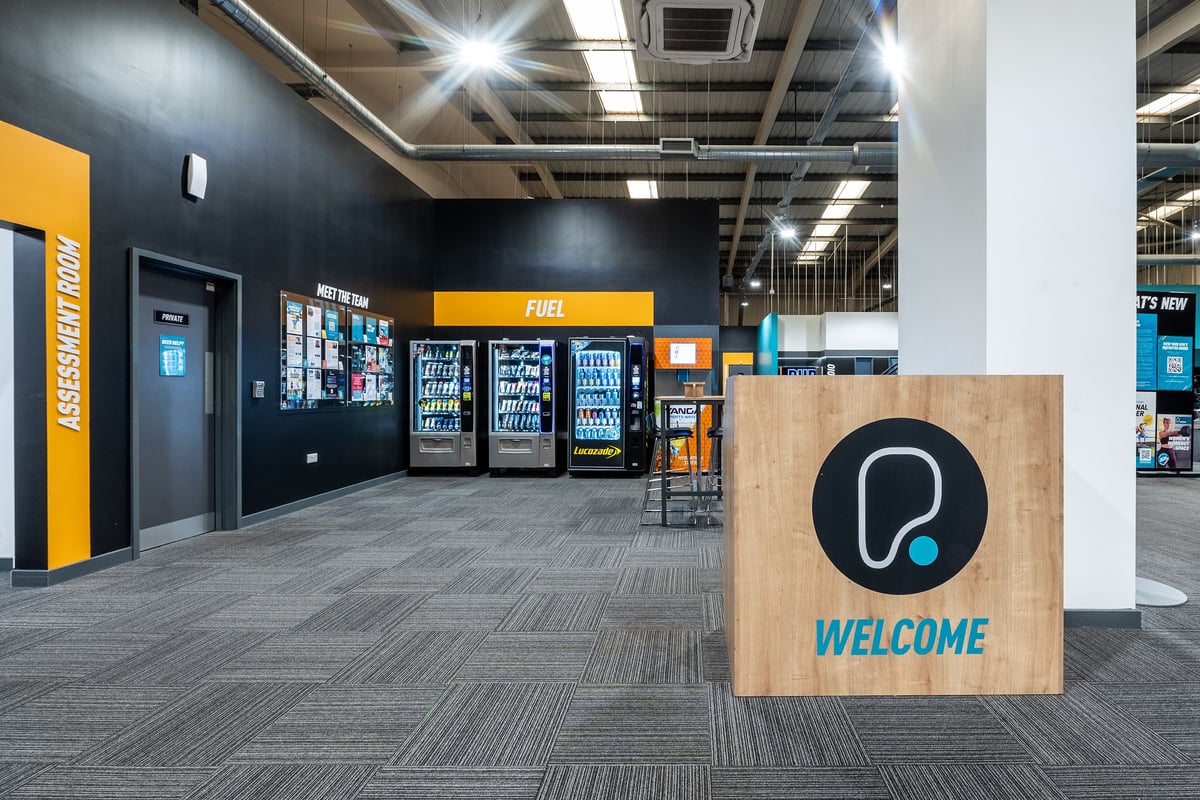 PureGym Weston-super-mare: Vending machines, welcome sign, and tiled flooring in what appears to be a commercial space.