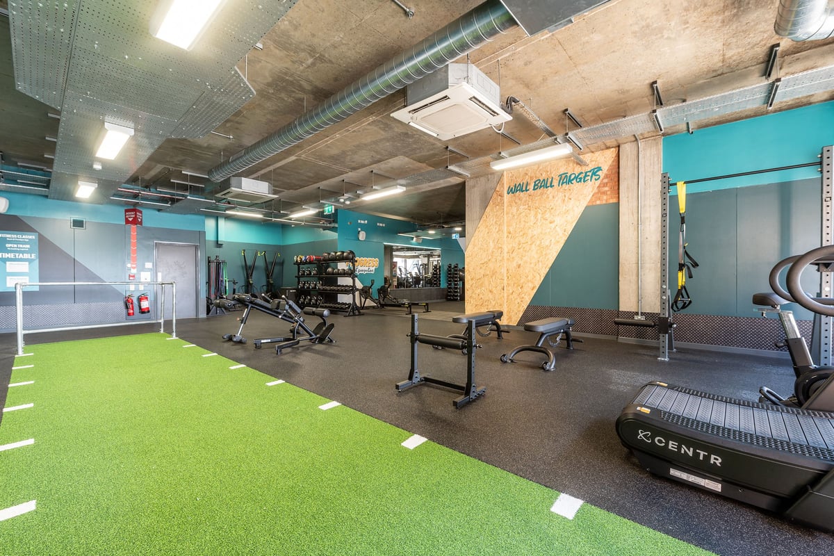 PureGym London Limehouse: Treadmills, cycle trainers, weight racks, resistance machines, matted turf area.