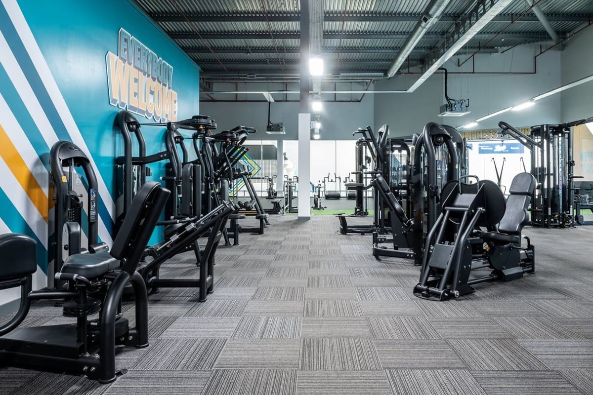 PureGym Peterborough Serpentine Green Shopping Centre: Resistance machines, benches, and rubberized flooring in a modern gym.