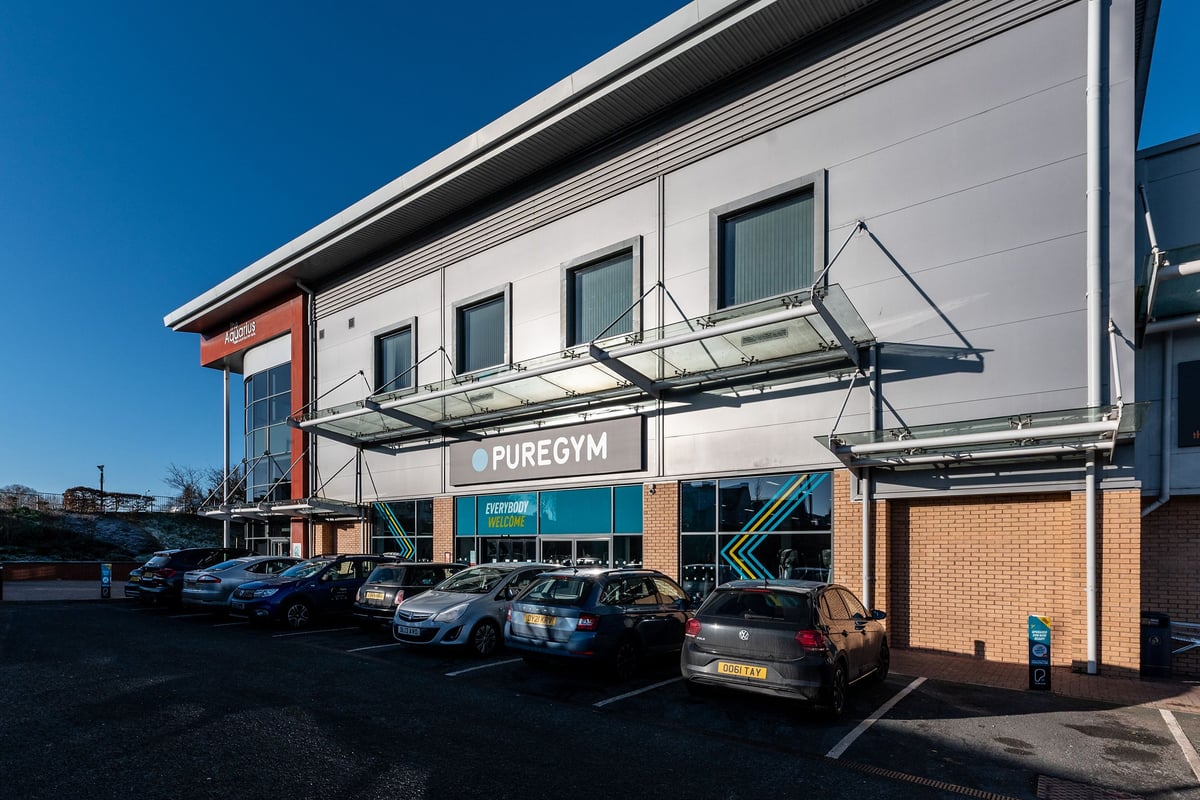 PureGym Hednesford Cannock: Exterior of gym with signage, parking spaces, and awnings over entrance.