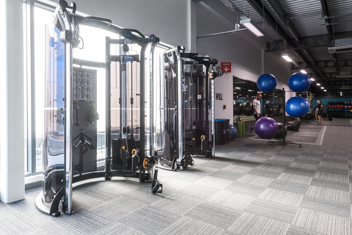 PureGym Leeds Thorpe Park: Multi-station functional trainers, resistance machines, exercise balls in a modern gym interior.