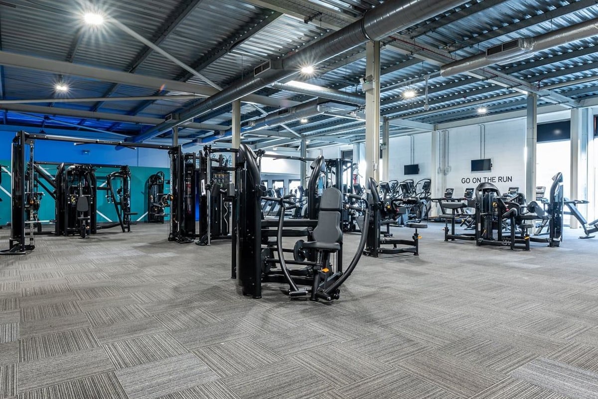 PureGym Bristol Union Gate: Weight machines, resistance equipment, benches, and rubberised flooring in a well-lit gym area.