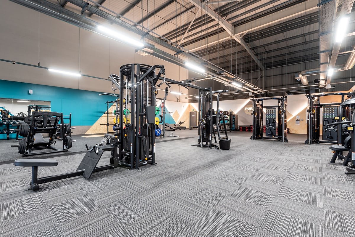 PureGym Harwich: Resistance machines, weight racks, rubberized flooring in a spacious gym interior.