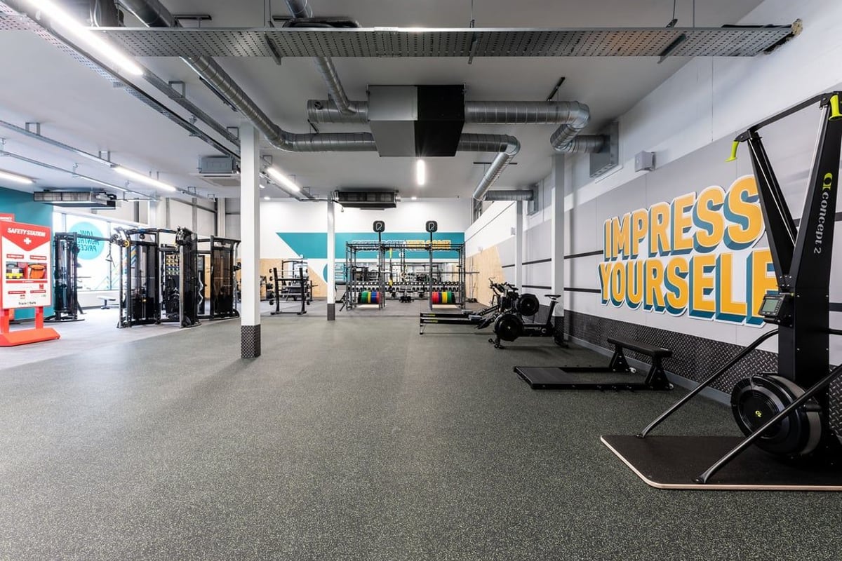 PureGym Galashiels: Squat racks, cable machines, weightlifting platforms, and emblazoned motivational signage.