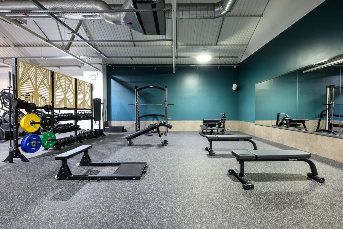 PureGym Glasgow Charing Cross stretch area with benches and large mirror
