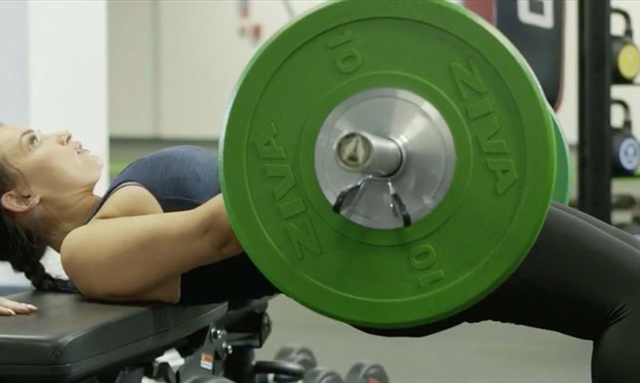 Woman doing barbell hip thrusts